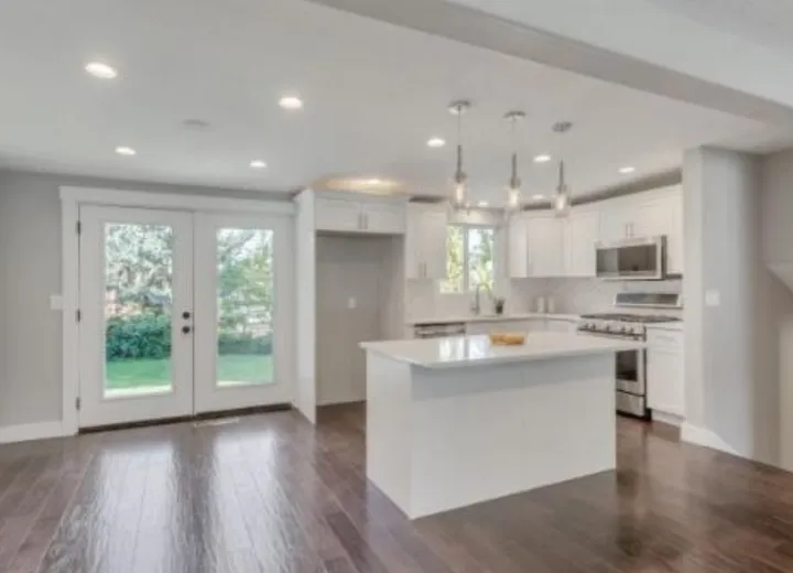 White shaker kitchen with island and pendant lights