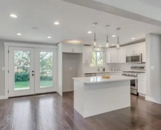 White shaker kitchen with island and pendant lights