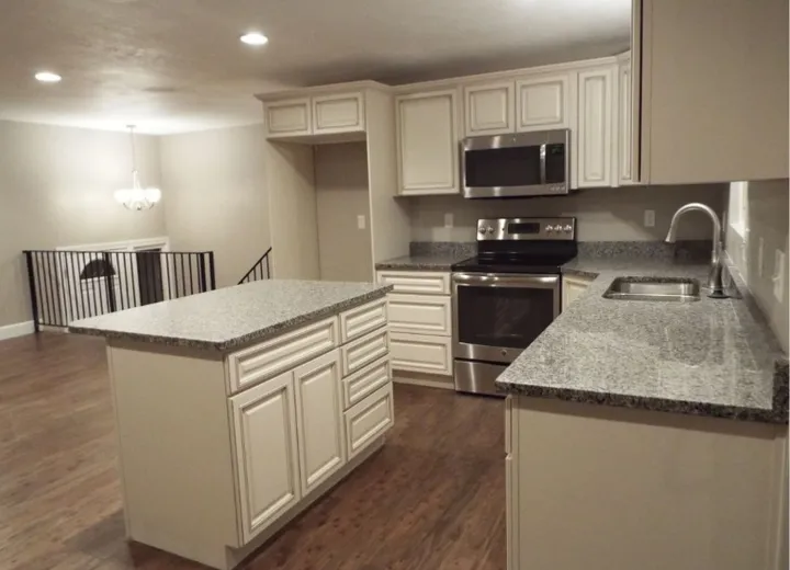 Remodeled kitchen with cream cabinets and granite counters