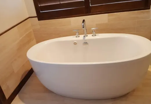 Finished bathroom vanity with mirrors and tile floor