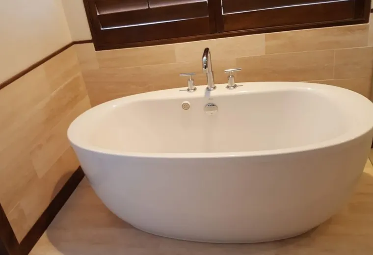 Finished bathroom vanity with mirrors and tile floor