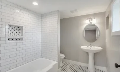 Rebuilt bathroom with subway tile tub surround and pedestal sink